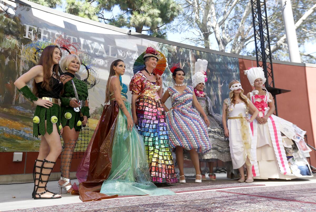 Artists and models pose for a group picture after the Festival Runway Fashion Show at the Festival of Arts on Sunday.