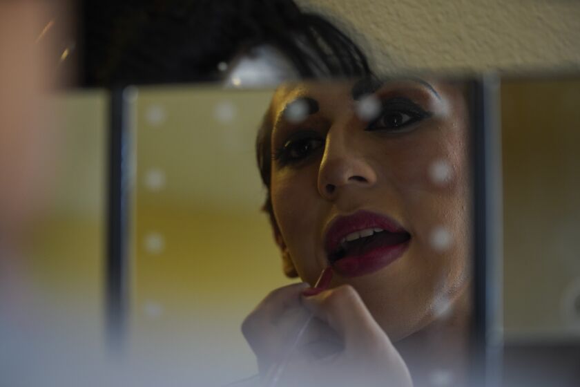 San Diego, California - April 03: Drag queen Lady Blanca getting ready to transform into Tejano artist Selena Quintanilla. She paints her lips in her apartment in the College Area on Saturday, April 3, 2021 in San Diego, California (Alejandro Tamayo / The San Diego Union-Tribune)
