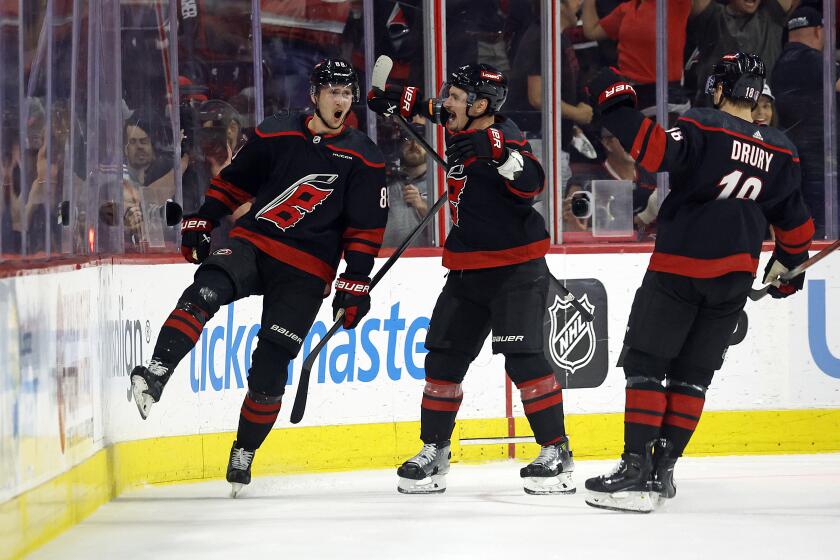 Carolina Hurricanes' Martin Necas, left, celebrates his goal against the New York Rangers with Dmitry Orlov, center, and Jack Drury (18) during the first period in Game 6 of an NHL hockey Stanley Cup second-round playoff series in Raleigh, N.C., Thursday, May 16, 2024. (AP Photo/Karl B DeBlaker)