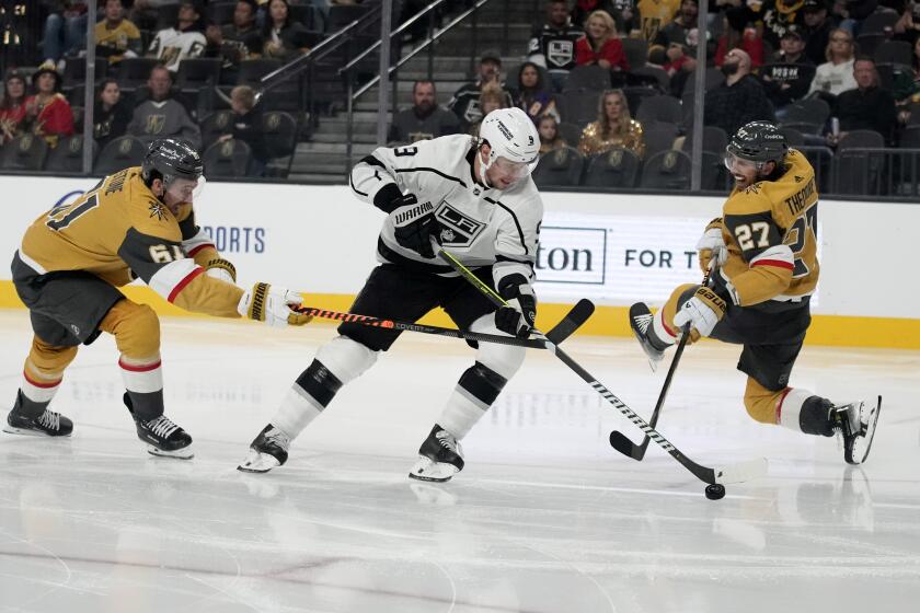 Vegas Golden Knights right wing Mark Stone (61) commits a hooking penalty on Los Angeles Kings center Adrian Kempe (9) during the third period of an NHL hockey game Wednesday, Nov. 8, 2023, in Las Vegas. (AP Photo/John Locher)