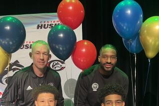 Corona Centennial coaches Josh Giles (left) and Shannon Sharpe with Carter Bryant and Eric Freeny,