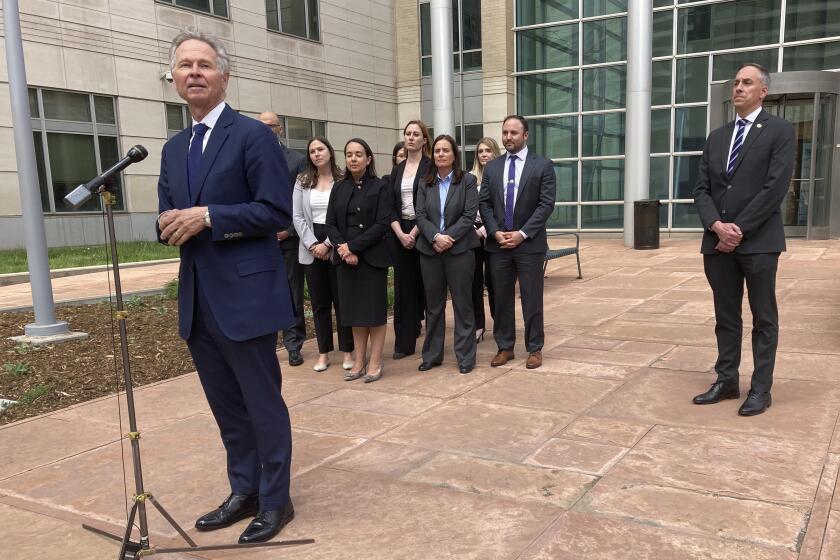 U.S. Attorney for Colorado Cole Finegan, left, speaks outside Denver federal court after the sentencing of Jared Sebastian Dalke on Monday, April 29, 2024, in Denver. Behind him are federal prosecutors and FBI Special Agent in Charge Mark Michalek. Former National Security Agency employee Dalke, who sold classified information to an undercover FBI agent he believed to be a Russian official, was sentenced Monday to nearly 22 years in prison, the penalty requested by government prosecutors. (AP Photo/Colleen Slevin)
