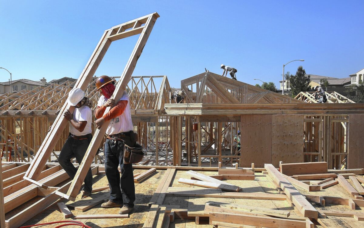 Workers put up framing of a home under construction in Porter Ranch in October.