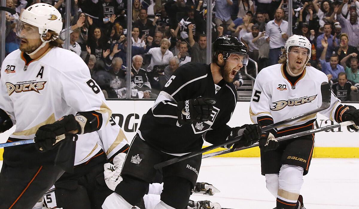 Kings defenseman Jake Muzzin (6) reacts after scoring against Teemu Selanne (8), Patrick Maroon (62) and the Ducks in the first period Wednesday night at Staples Center.