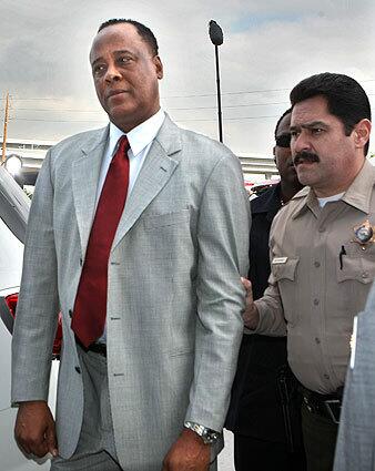 Dr. Conrad Murray, the physician who was with Michael Jackson at the time of the music legend's death in 2009, is escorted by a law enforcement officer into the Airport Courthouse in Los Angeles. Murray is now serving time for involuntary manslaughter.