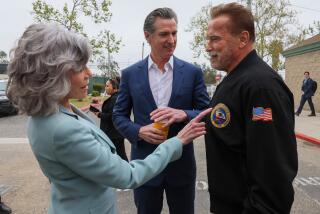 Los Angeles, CA, Friday, March 22, 2024 - California Governor Gavin Newsom looks on as Jane Fonda notices former Governor Schwarzenegger's official jacket as they arrive deliver speeches at a press event sponsored by Campaign for a Safe and Healthy California at a Ladera Heights soccer field. (Robert Gauthier/Los Angeles Times)
