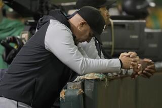 White Sox manager Pedro Grifol looks down in the dugout during a game against the Athletics