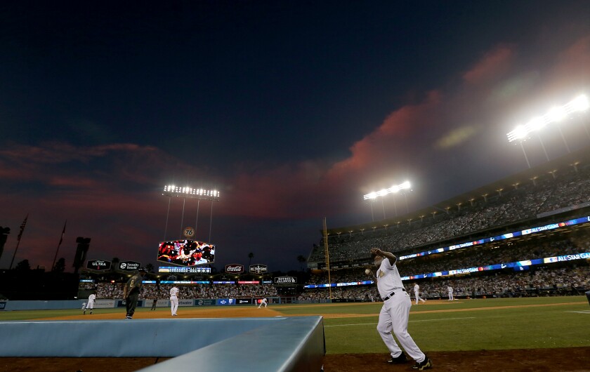 The setting sun casts a rosy glow over Dodger Stadium during the MLB All-Star Game on Tuesday night.