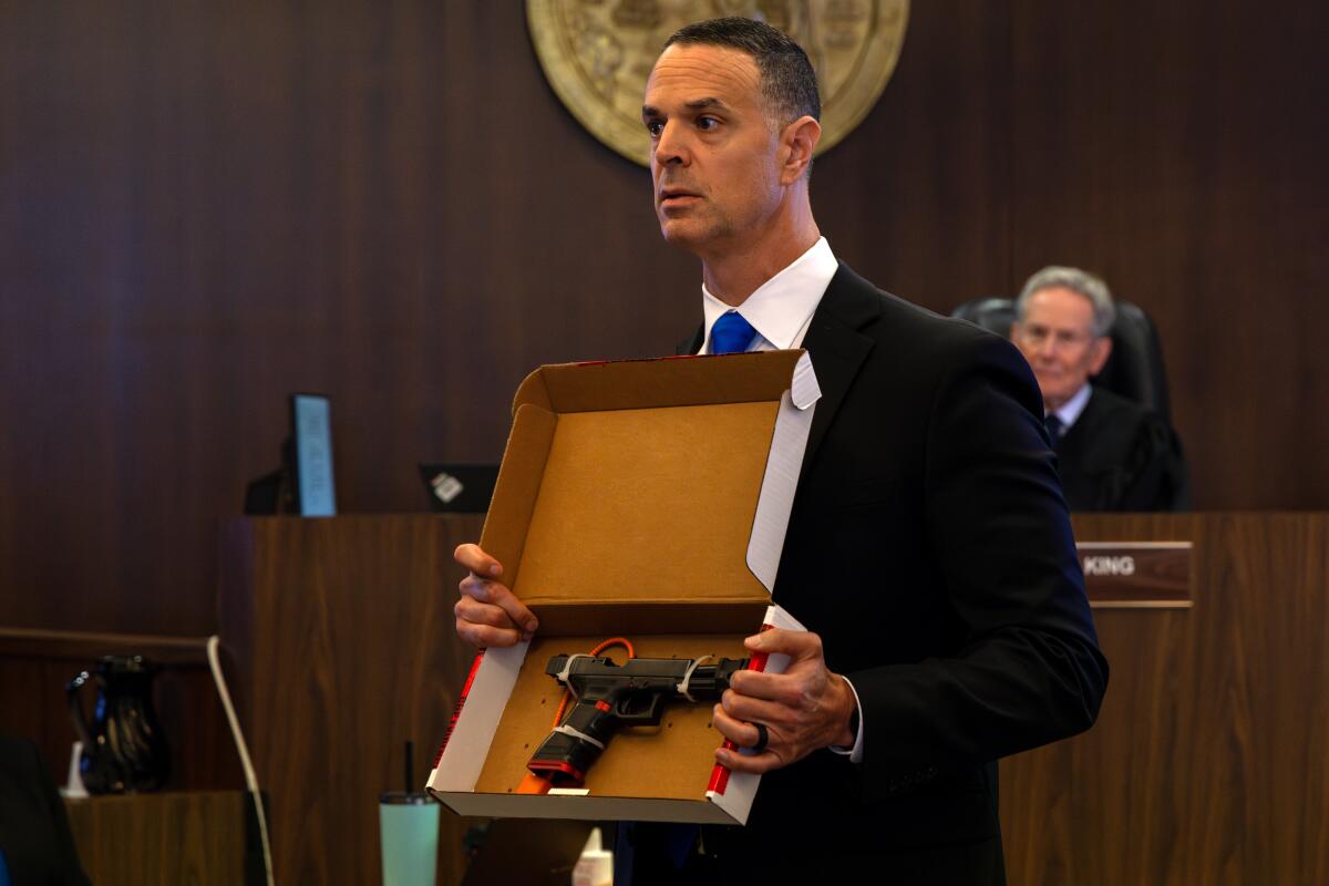 Senior Deputy Dist. Atty Daniel Feldman displays to the jury a gun used by Marcus Anthony Eriz.