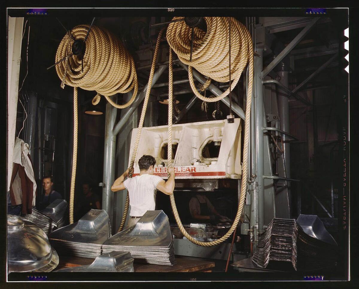 Huge drop hammers day and night forming sheet metal parts for B-25s and P-51s built at the North American Aviation Inc. plant in Inglewood in October 1942.