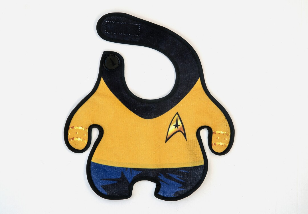 A baby bib in the shape of a Star Trek uniform