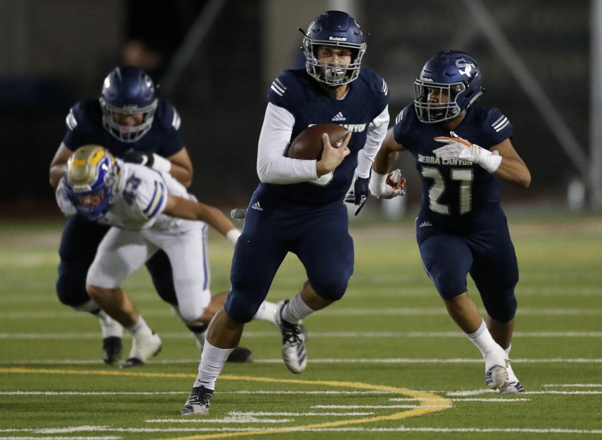 Sierra Canyon quarterback Chayden Peery scrambles out of the pocket against Santa Margarita during the Division 2 playoffs. He has been intercepted once in 14 games.