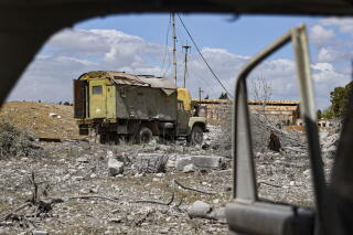 Debris is scattered at the site of an Israeli strike on a military airbase near Ham