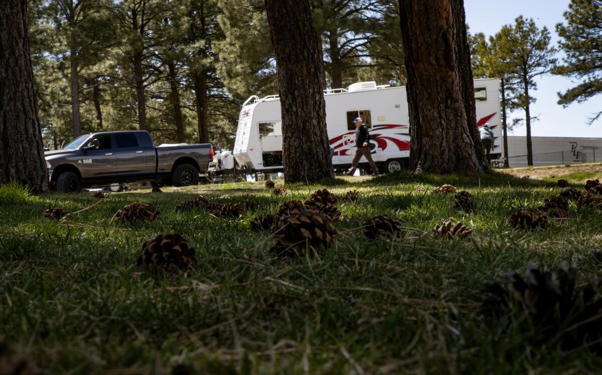 A family sets up their RV at Black Bart's RV Park in Flagstaff, Ariz., mid-pandemic.