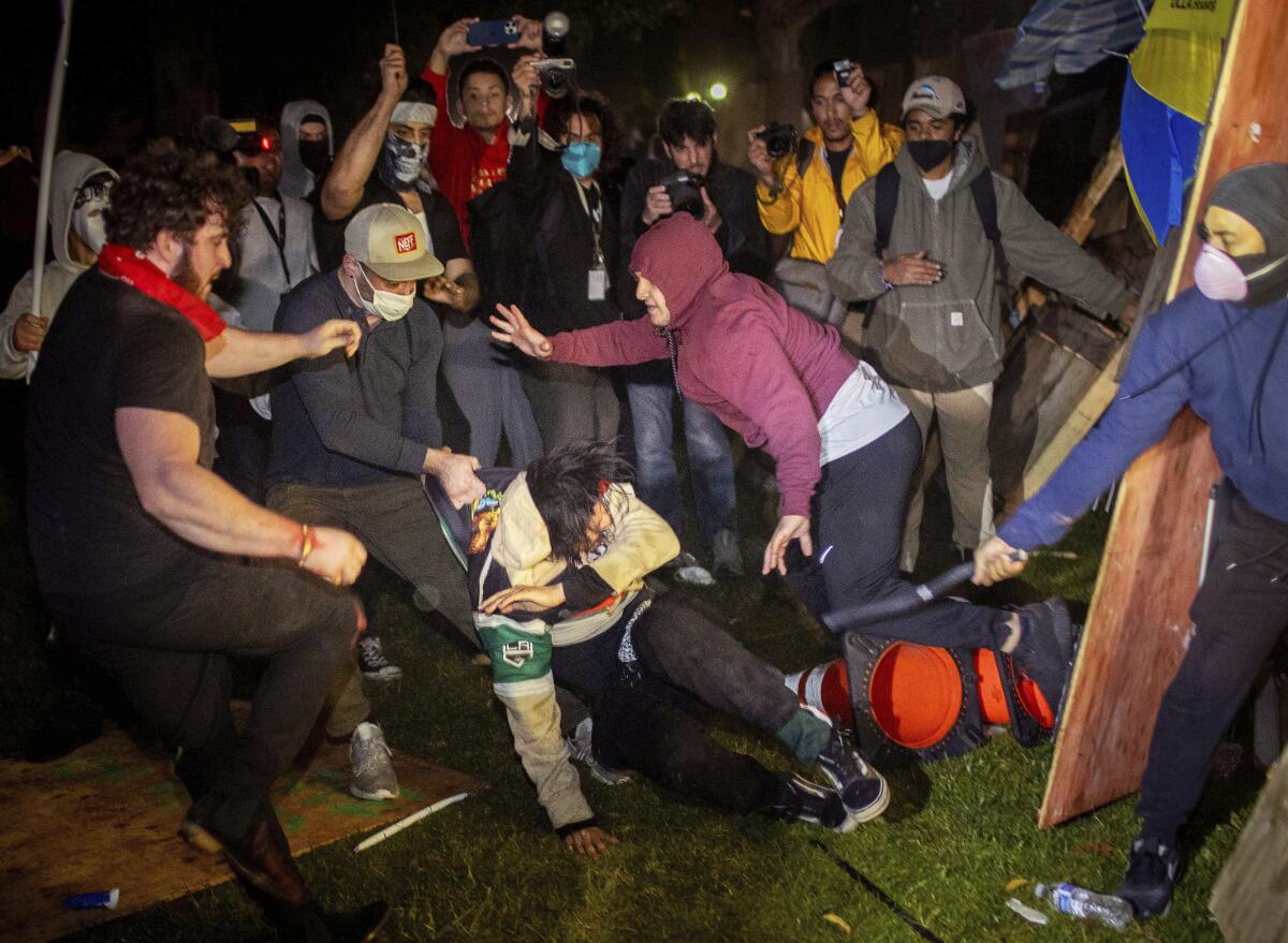 Demonstrators clash at an encampment at UCLA