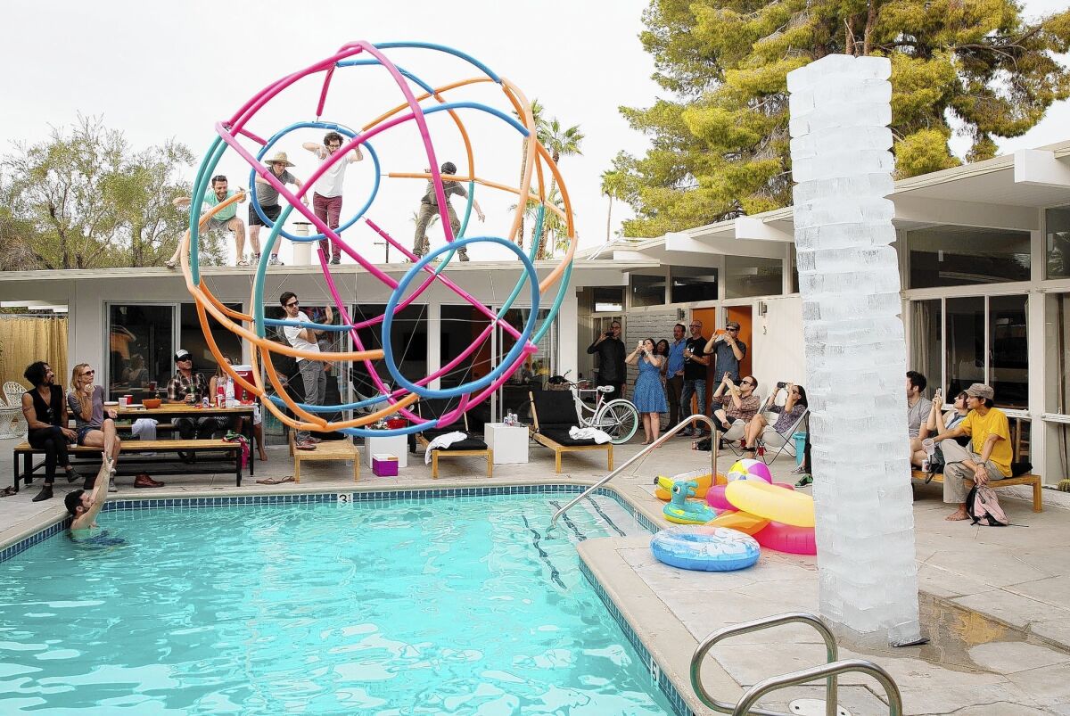 David Freeland, Terry Chatkupt, Mark Lyons and Peter Vikar launch "Deep End," a 12-foot wire-frame beach ball, from the roof of the Amado into the pool. The event was part of On the Road Project LA.