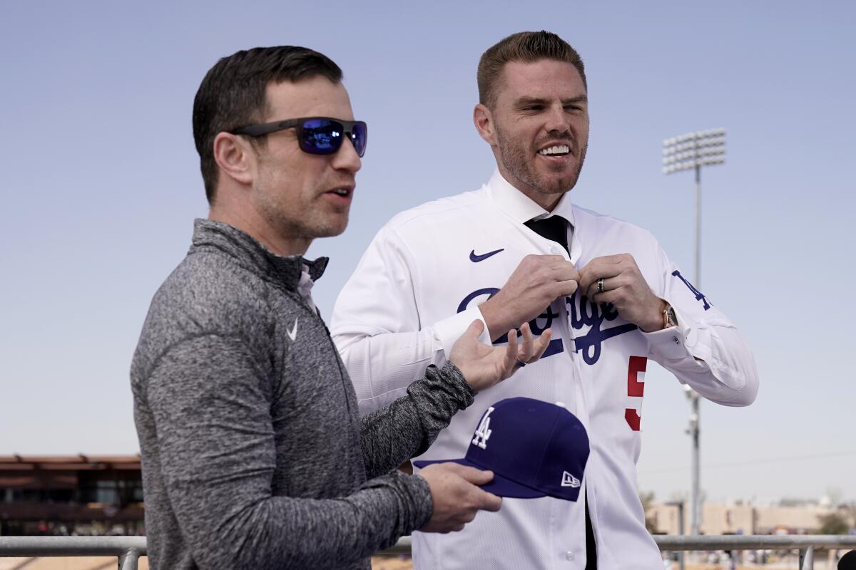 Dodgers president of baseball operations Andrew Friedman, left, introduces star signing Freddie Freeman.