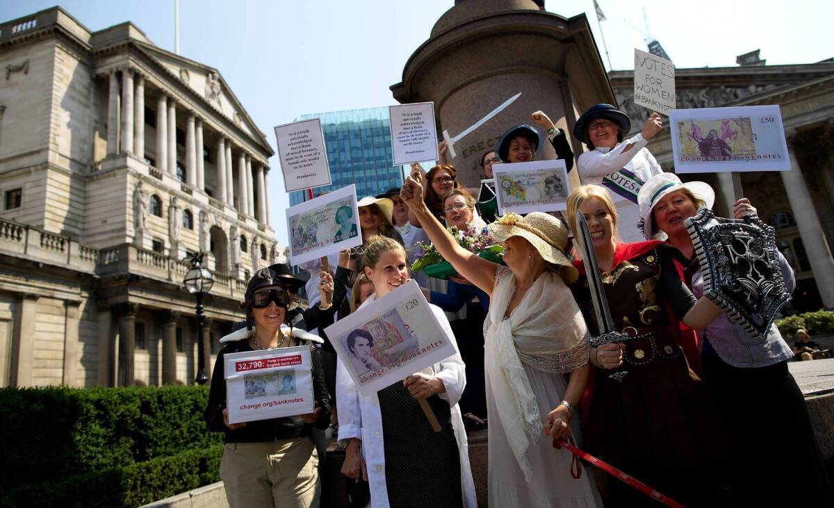 In London, campaigners dressed as famous women from history deliver to the Bank of England a petition calling for female representation on bank notes.