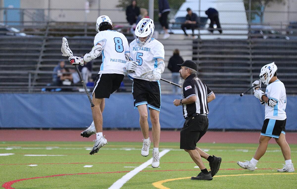 Teammates Mick Lohr (left) and Sammy Sharpe celebrate a goal In Palisades’ 14-5 victory for the City Section title Wednesday.