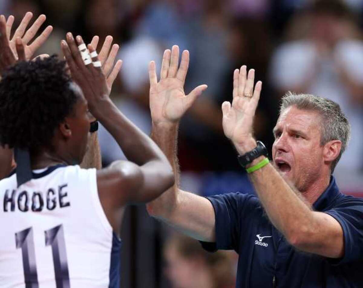 Assistant coach Karch Kiraly of the United States celebrates a win over China with Megan Hodge.