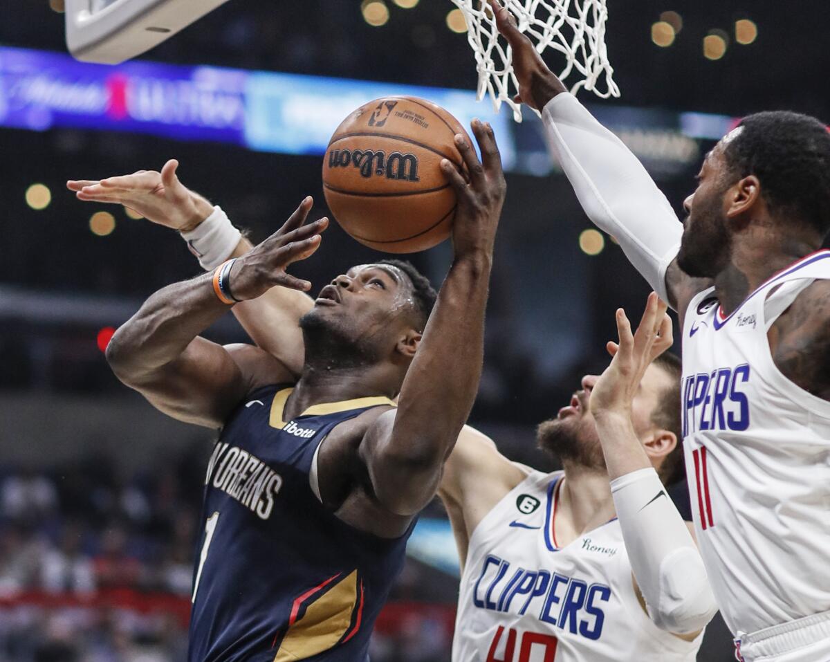 The Clippers defend against an attempted Pelicans layup.
