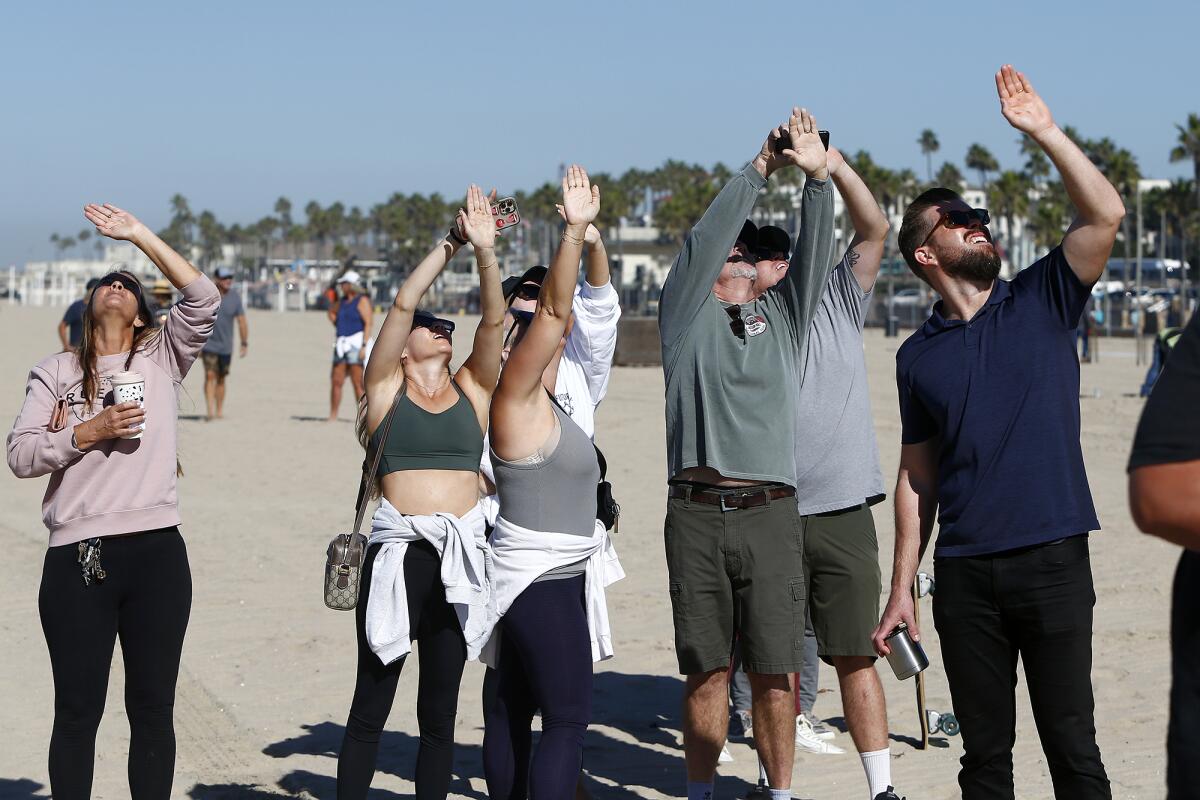 Friends and family look to the sky as they watch Don Ramsey tandem jump out of a plane with the Navy Leap Frogs on Thursday.