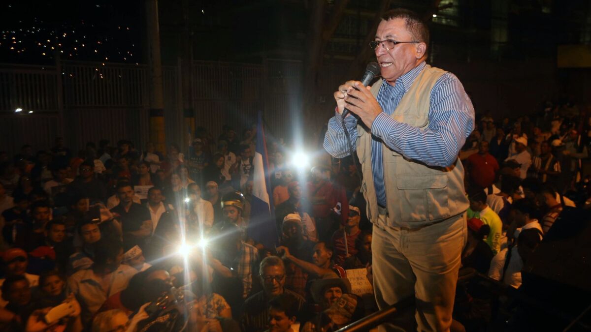 Bartolo Fuentes, a former congressman in Honduras, speaks during a demonstration in front of the U.S. Embassy in Tegucigalpa in support of migrants participating in a caravan to the Unites States on Oct. 19, 2018.
