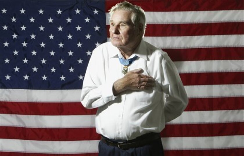 In this photo taken Oct, 23, 2007, World War II veteran Russell Dunham, of Godfrey, Ill., poses for a portrait. Dunham, a recipient of the Medal of Honor after killing nine German soldiers and taking two others captive while wounded during a World War II battle, died Monday, April 6, 2009, of heart failure at his home. He was 89. Dunham won the nation's highest military honor for his heroics during a January 1945 battle near Kayserberg, France. (AP Photo/The Telegraph, Jim Bowling)