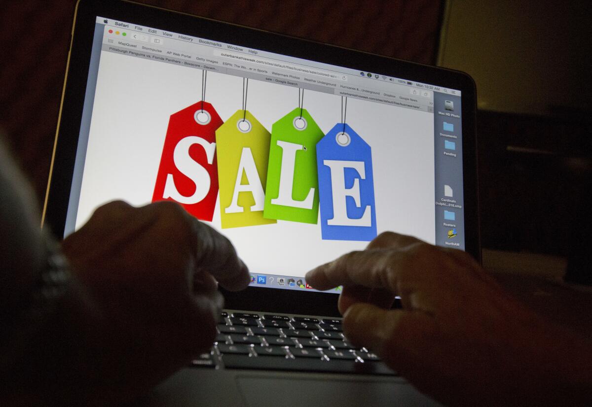 A person searches the internet for sales