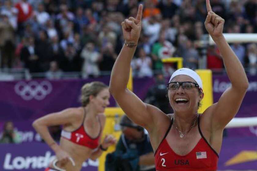 Misty May-Treanor, right, and Kerri Walsh-Jennings celebrate after defeating China in their semifinal women's beach volleyball match.