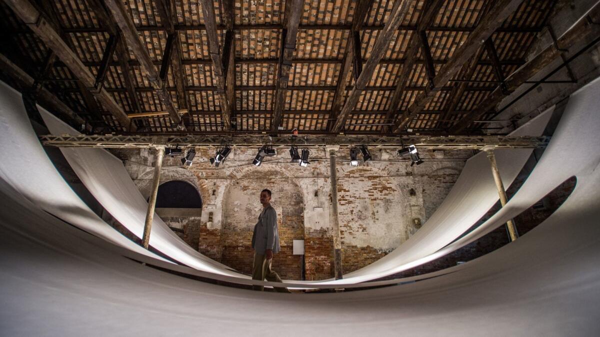 A man walks through "Sunyata: The Poetics of Emptiness," in the Indonesian pavilion.