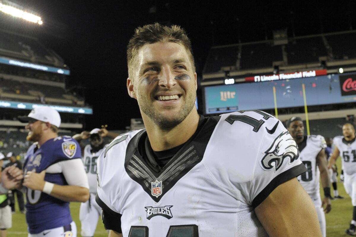 FILE - In this Aug. 22, 2015, file photo, Philadelphia Eagles' Tim Tebow walks off the field after a preseason NFL football game against the Baltimore Ravens in Philadelphia. Tebow and coach Urban Meyer are together again, this time in the NFL and with Tebow playing a new position. The former Florida star and 2007 Heisman Trophy-winning quarterback signed a one-year contract with the Jacksonville Jaguars on Thursday, May 20, 2021, and will attempt to revive his pro career as a tight end. (AP Photo/Michael Perez, File)