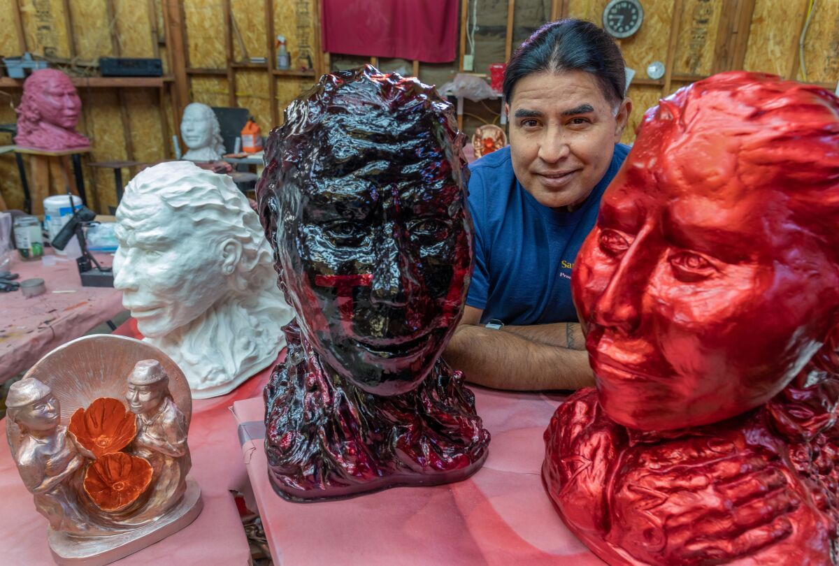 Johnny Bear Contreras at his studio on the San Pasqual Valley Reservation in Valley Center, surrounded by his sculptures