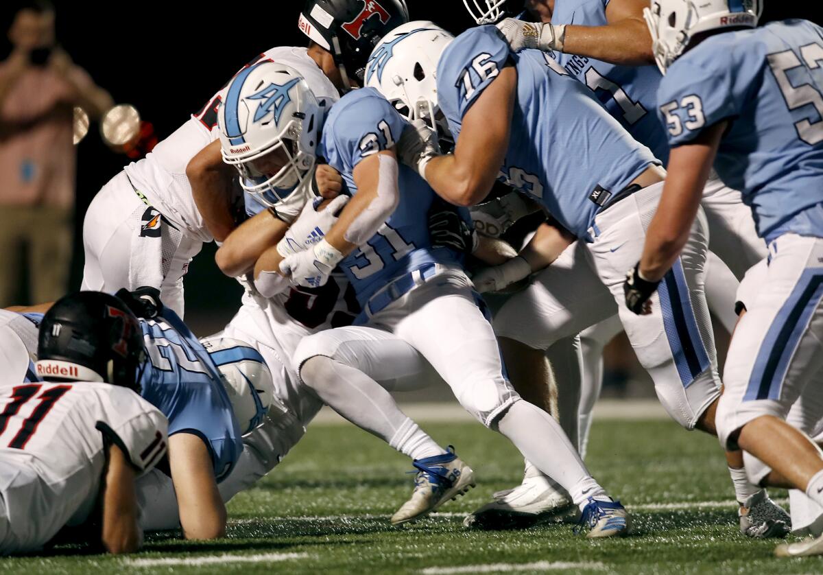Corona del Mar running back Riley Binnquist (31) pushes into the end zone for a one-yard touchdown against San Clemente in the second quarter at Newport Harbor High on Thursday.