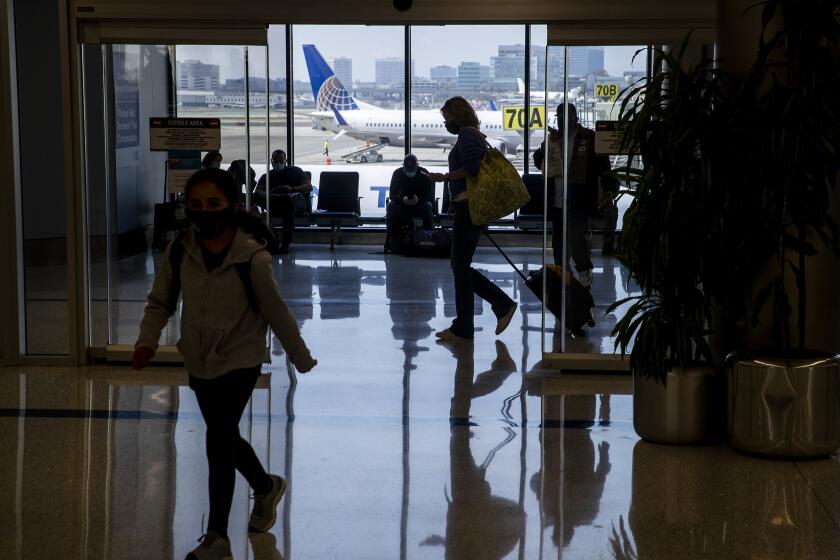 Los Angeles, CA - May 28: Amid a busy getaway travel day for the Memorial Day weekend and the first holiday since coronavirus pandemic restrictions have been relaxed, travelers make their way to their destinations at LAX, United Airlines, Terminal 7 in Los Angeles Friday, May 28, 2021. Officials say travelers should arrive early for Memorial Day weekend flights. After months of Los Angeles International Airport looking like a ghost town, holiday crowds are back. "We're seeing more travelers than we've seen in the last 14 months. We had over 75,000 people come through on Sunday alone to the TSA checkpoints, that's by far a record in 2021 for us," said LAX spokesperson Keith Montgomery. Photo taken in LAX on Friday, May 28, 2021 in Los Angeles, CA. (Allen J. Schaben / Los Angeles Times)