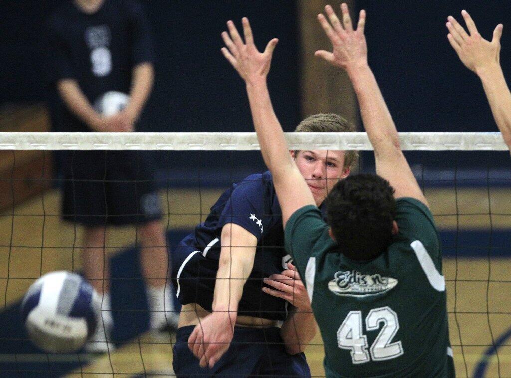 Newport Harbor High's Clay Carr, left, scores against Edison's Jack Dorman (42) during a Sunset League match on Tuesday.