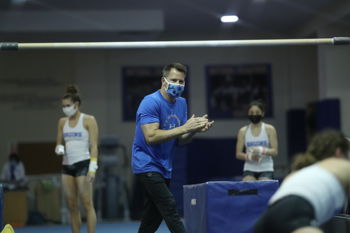 UCLA gymnastics coach Chris Waller gives encouragement during a team practice session on Jan. 8, 2021.