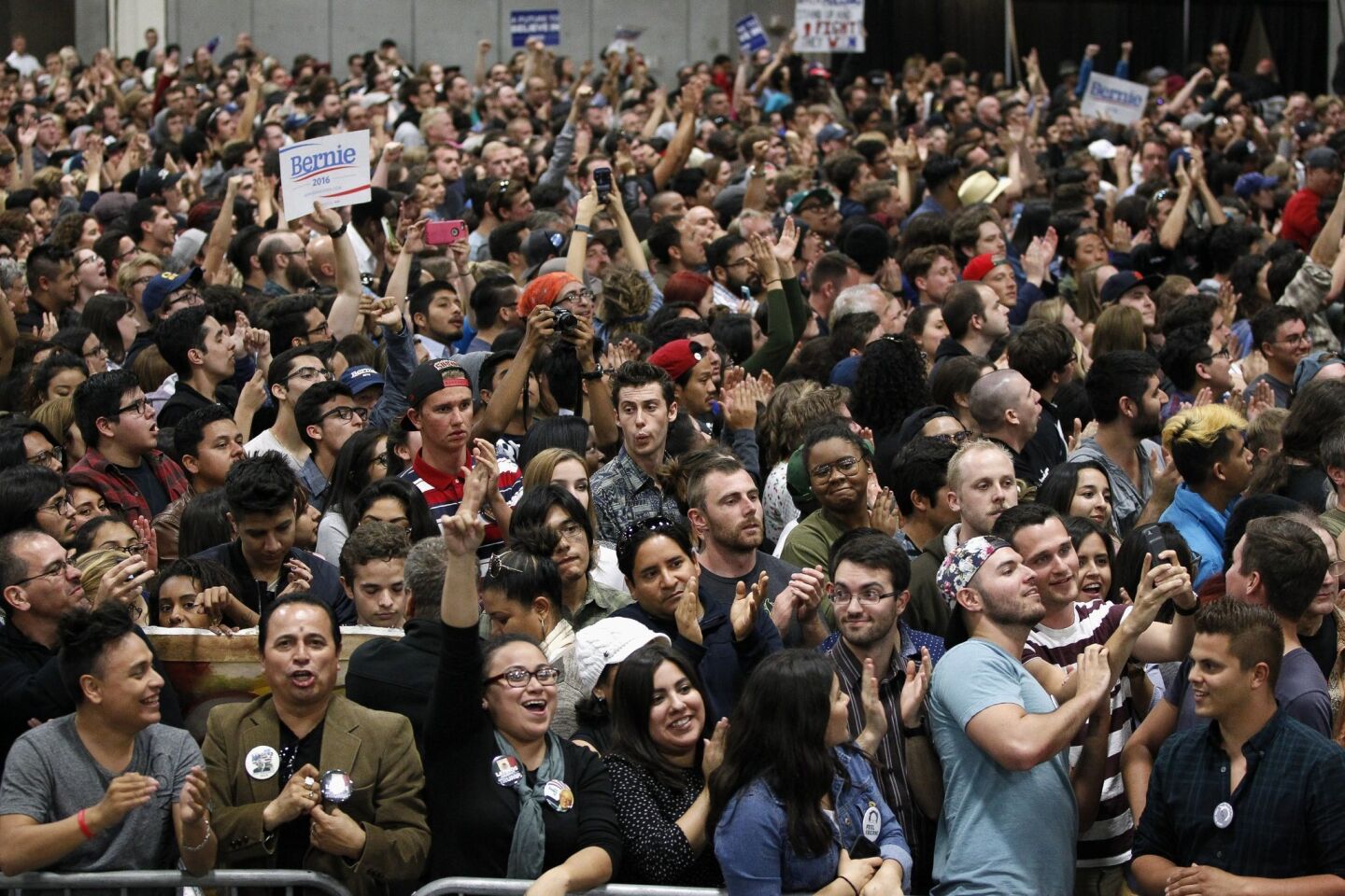 Supporters listen to Democratic presidential candidate Bernie Sanders.