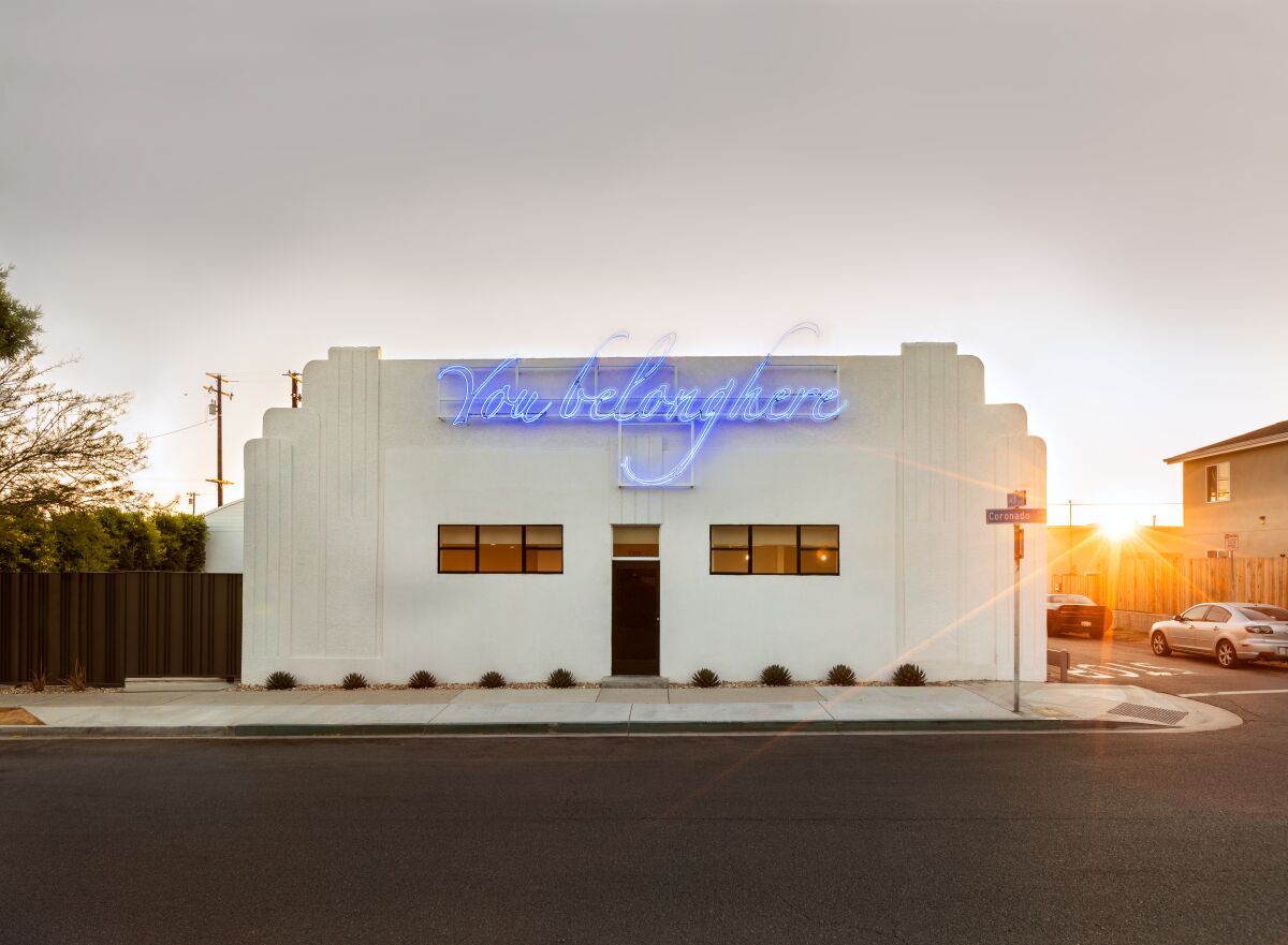 Tavares Strachan's neon work, on the facade of Compound.