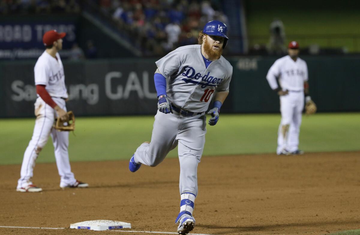 Dodgers third baseman Justin Turner rounds the bases after hitting a two-run home run in the eighth inning against the Texas Rangers on June 16.