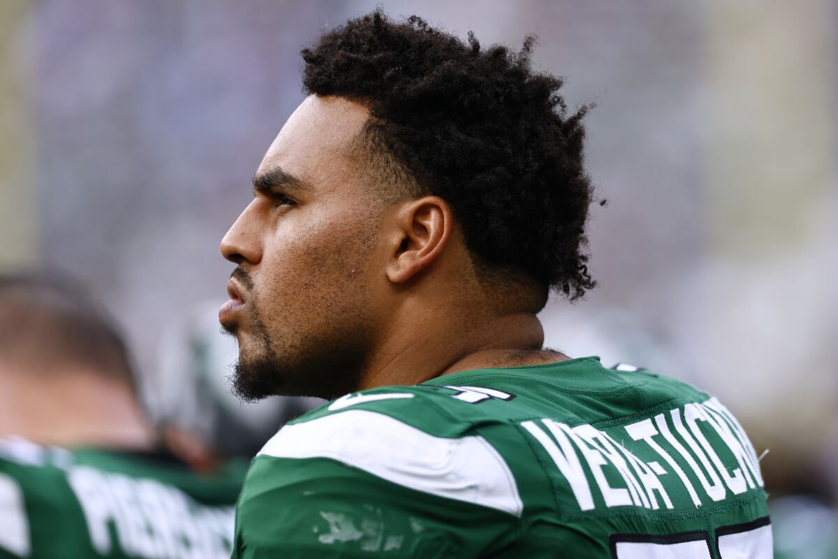 New York Jets guard Alijah Vera-Tucker (75) looks on during an NFL pre-season football game against the New York Giants, Aug. 27, 2022, in East Rutherford, N.J. Vera-Tucker had an impressive rookie season for the Jets last year as their left guard. The first-round draft pick moved to left guard this season because of injuries on the offensive line, and then made his first start at left tackle last Sunday. Vera-Tucker's versatility has earned the ultimate respect of his teammates, with one declaring he'll one day join the Jets' Ring of Honor. (AP Photo/Rich Schultz)