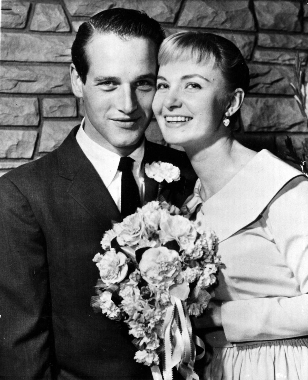 Paul Newman and Joanne Woodward smile together in 1958