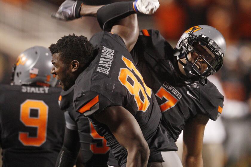 Oklahoma State wide receiver Justin Blackmon, left, celebrates with teammate Michael Harrison in 2011.