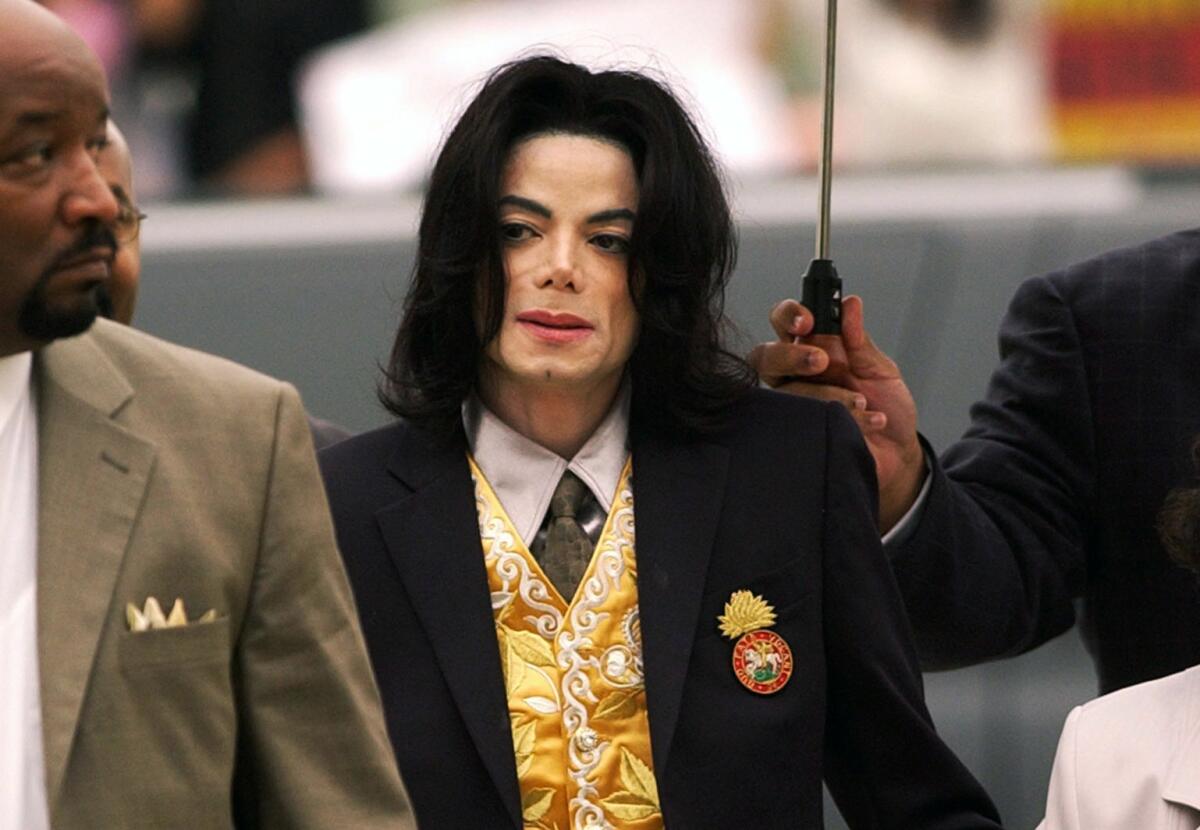 FILE - In this May 25, 2005, file photo, Michael Jackson arrives at the Santa Barbara County Courthouse for his trial in Santa Maria, Calif. On Monday, May 3, 2021, a U.S. tax court handed a major victory to Jackson's estate in a years-long battle, finding that the IRS inflated the value of Jackson’s assets and image at the time of his 2009 death. (Aaron Lambert/Santa Maria Times via AP, Pool, File)