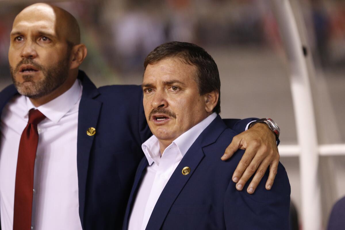 Costa Rica coach Oscar Ramirez, right, sings the national anthem prior to a 2018 World Cup qualifying soccer match against United States in San Jose, Costa Rica, Tuesday, Nov. 15, 2016. (AP Photo/Moises Castillo)