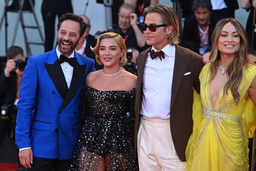 Four Hollywood stars, two men and two women, stand together in formalwear at a movie premiere