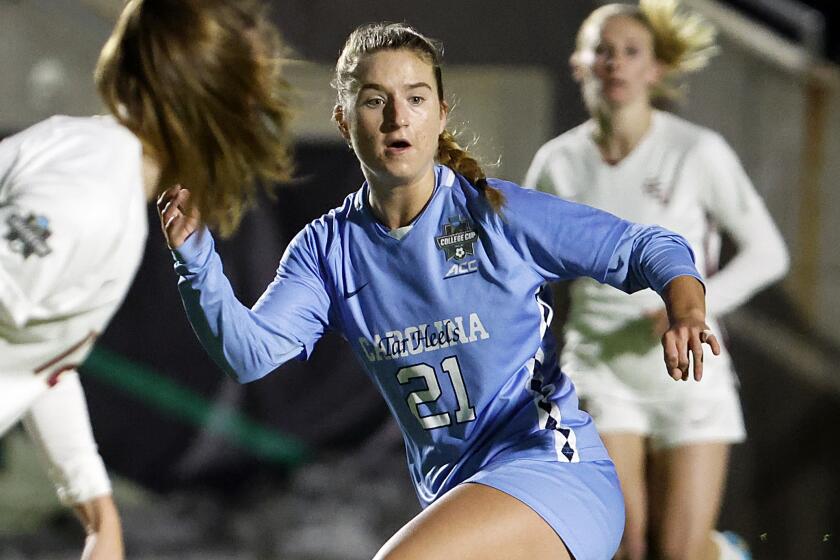FILE - North Carolina's Ally Sentnor (21) passes the ball during the first half of the team's NCAA College Cup.