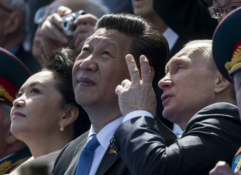 Russian President Vladimir Putin (right) speaks with Chinese President Xi Jinping in Moscow on May 9. The two leaders are said to be drawing closer partly because of their mutual disdain for Mikhail Gorbachev.