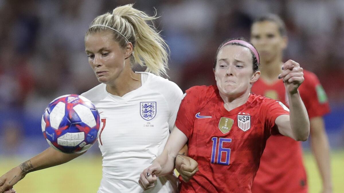 Rose Lavelle of the U.S,, right, vies for the ball with England's Rachel Daly during a Women's World Cup semifinal match Tuesday in Lyon, France.