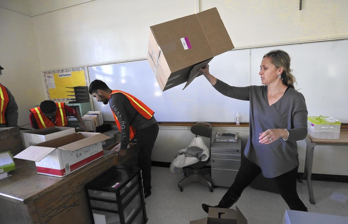 Rosie Van Zyl, a seventh- and eighth-grade science teacher at Porter Ranch Community School, gets her classroom at Northridge Middle School ready for students' first day back from winter break.